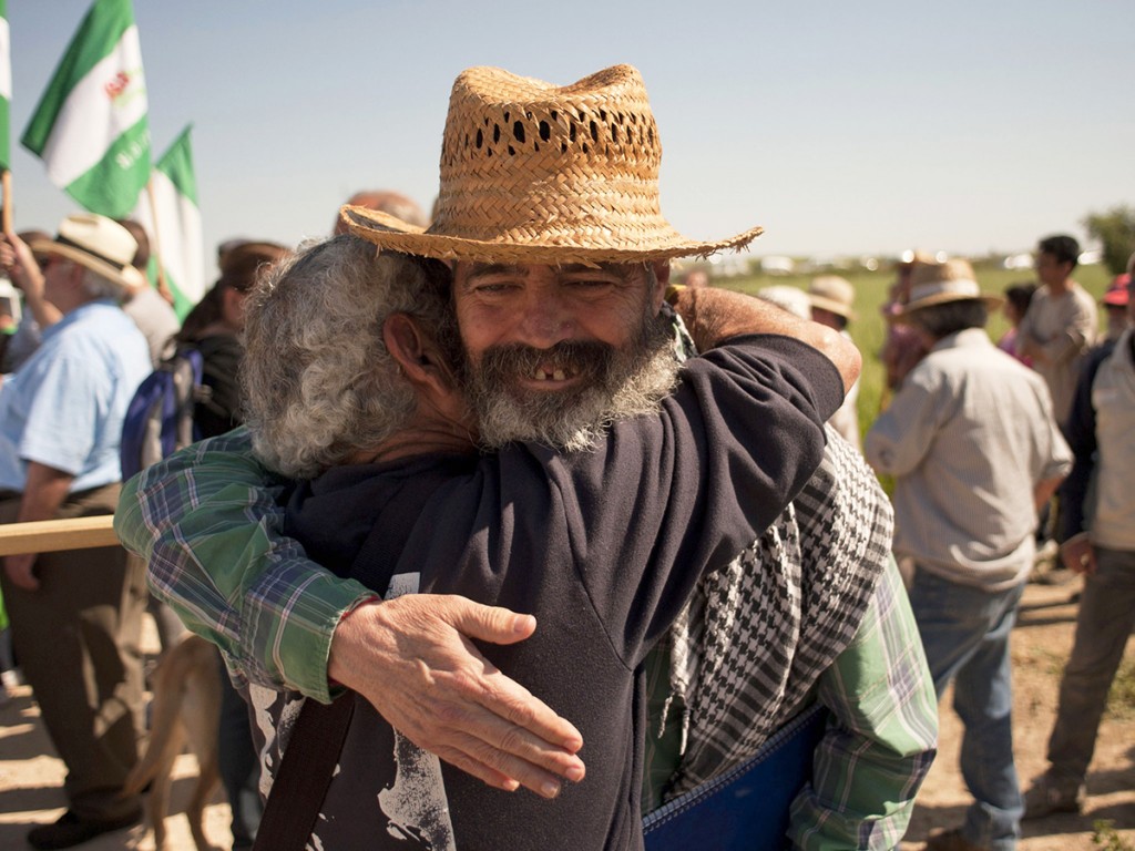 Mayor of Marinaleda and member of the regional Andalusian parliament representing the United Left (IU) party Manuel Sanchez Gordillo (R) embraces an activist of the Andalusian Union of Workers Union (SAT) as they take part to a protest during the occupation of ''Las Turquillas'', a 1,200-hectare plot of land owned by Spain's military, near the southern Spanish town of Osuna, on May 4, 2013. Some of the 500 unionists of the SAT (Andalusian Union of Workers Union) started on May 1 to occupy Las Turquillas, as they did 18 days last year, demanding to the Ministry of Defence to allow them to set up a communal agricultural project on the part of the land that is not used by militaries, more that 1,000 hectares. AFP PHOTO/ JORGE GUERREROJorge Guerrero/AFP/Getty Images