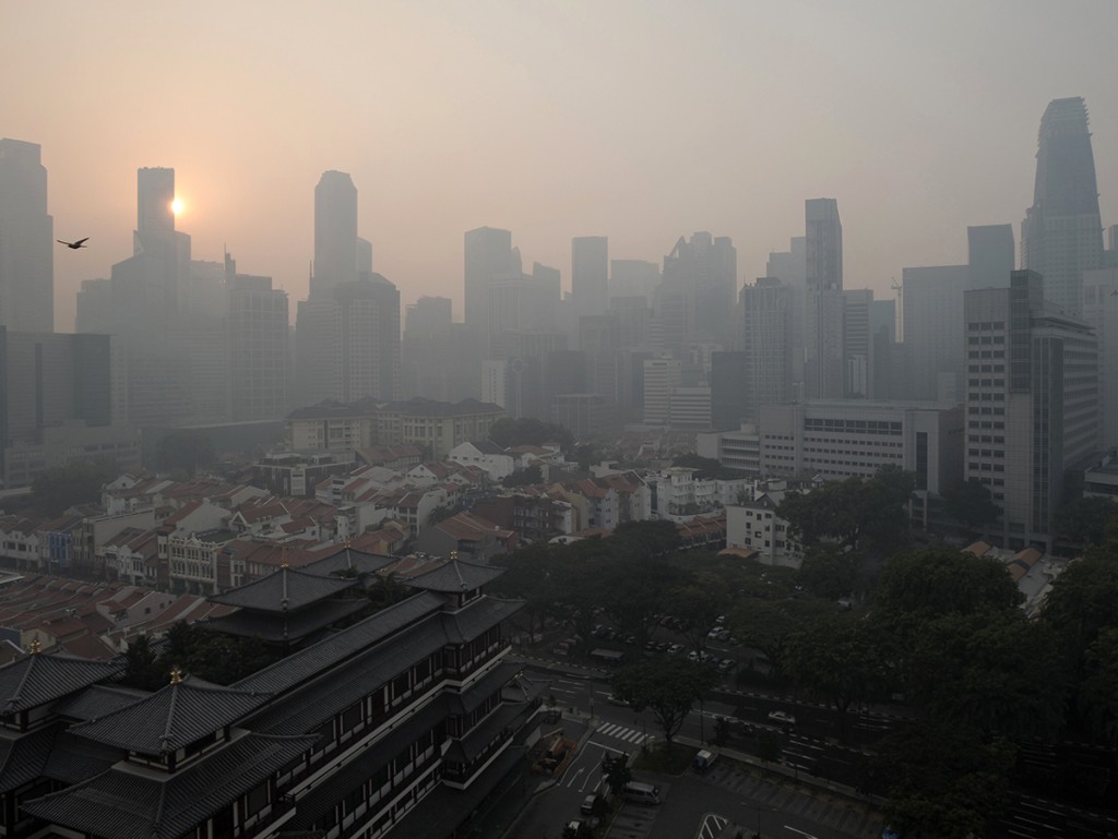 The sun rises over the Singapore Central Business District as smog shrouds the city-state on Thursday.